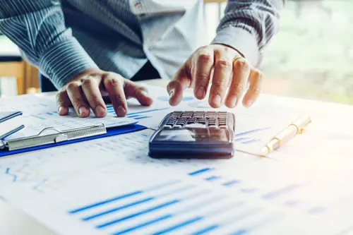 Man Reaching for Calculator