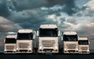 5 white Lorries in a Line